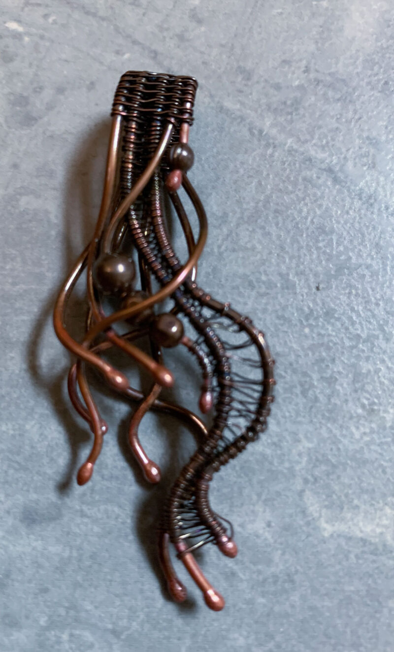 boho style pendant made from various lengths of copper wire, artfully twisted and interwoven
