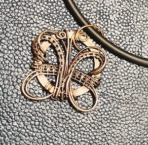 Photo of copper butterfly on black rubber chain with magnetic clasp