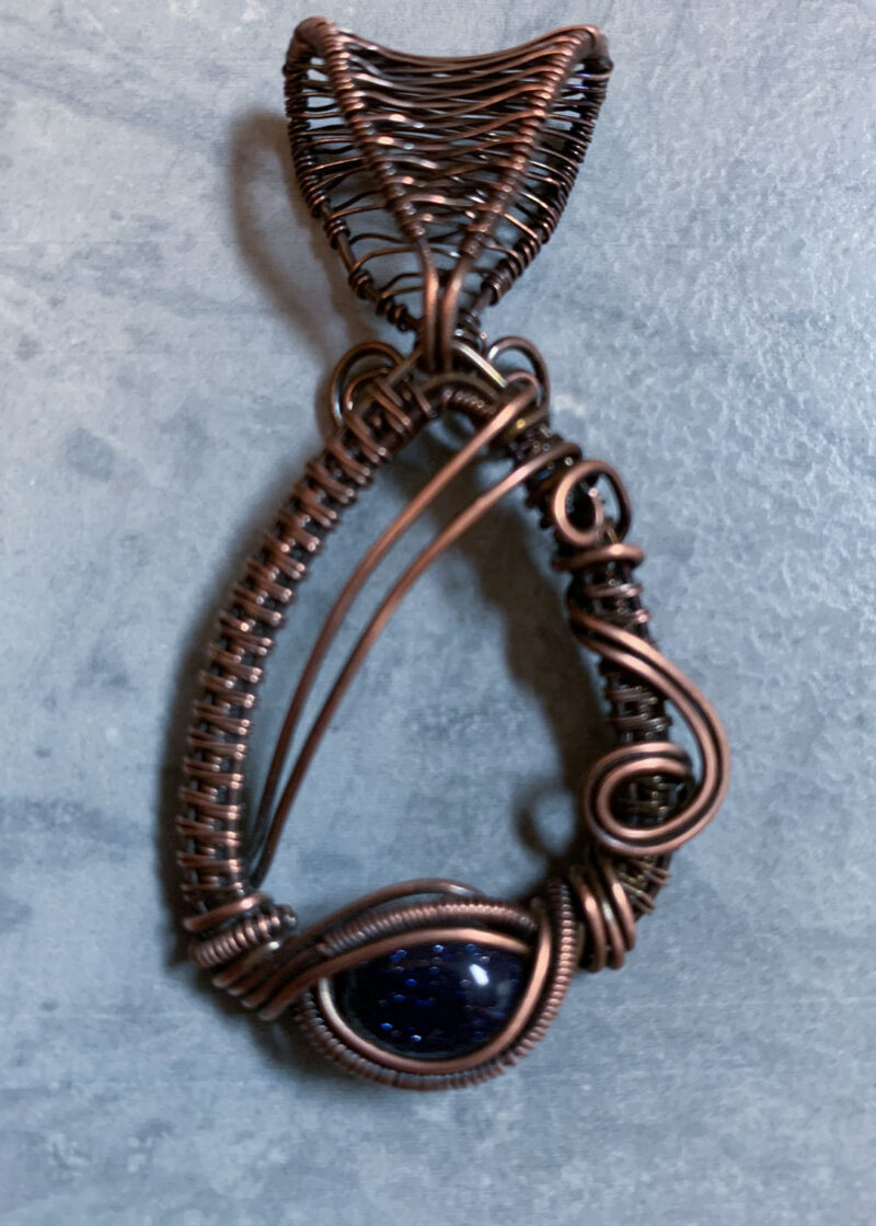 Wire wrapped jewelry - beautiful blue goldstone cabochon artfully wrapped in copper wire with an attached bail.
