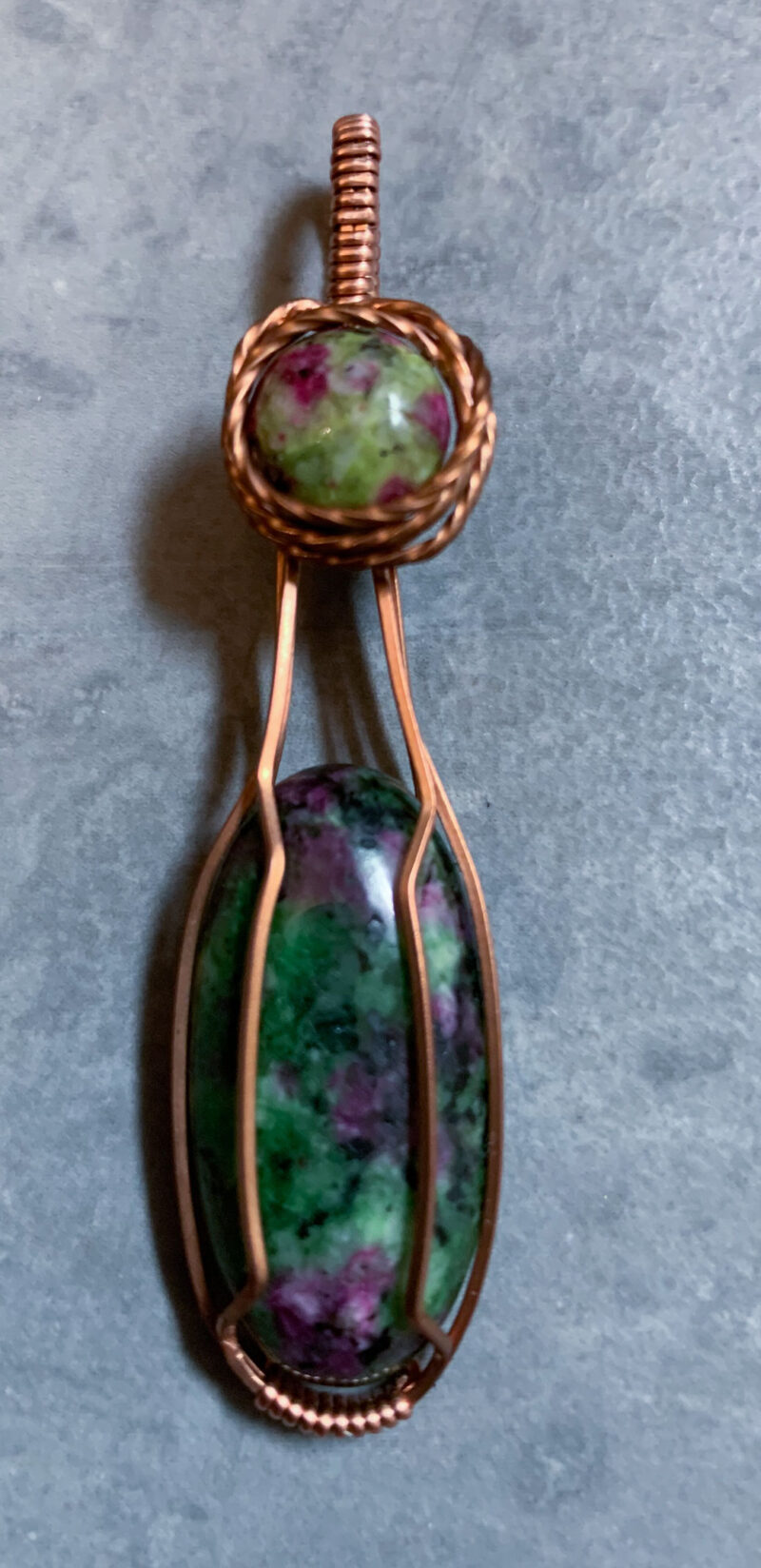 Two ruby in zoisite stones wrapped in copper wire