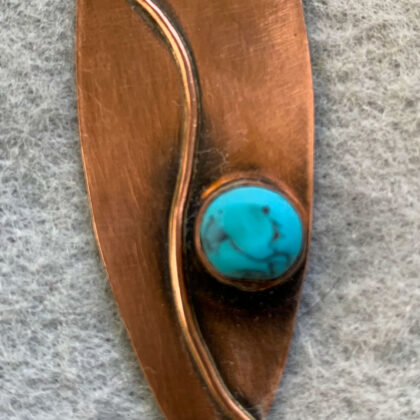 Photo of oxidized copper pendant with decorative wire trim and faux turquoise